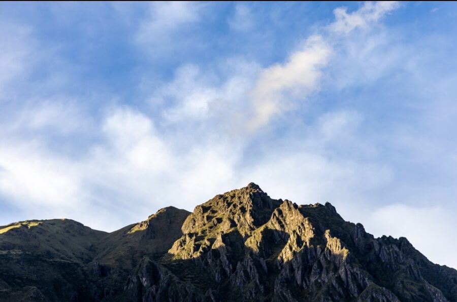 Montanha rochosa iluminada pelo sol ao entardecer nos Andes peruanos, cenário perfeito para lua de mel próxima a Cusco